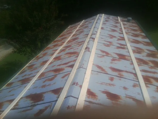 Rusted metal roof panels with new wood purlins before replacement — Storm Damage Roof Repair in North Bay by Roofing Brothers
